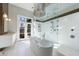 Bright bathroom boasts a soaking tub, modern lighting and glass-enclosed shower with multiple shower heads at 388 Beverly Ne Rd, Atlanta, GA 30309