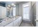 Granite countertop vanity with a shower visible in the mirror reflection at 388 Beverly Ne Rd, Atlanta, GA 30309