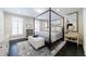 Bedroom featuring a canopy bed, wood flooring and an area rug at 388 Beverly Ne Rd, Atlanta, GA 30309