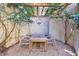 Outdoor dining area featuring a wooden table and chairs set on a gravel base, shaded by a pergola at 388 Beverly Ne Rd, Atlanta, GA 30309