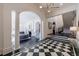 Elegant foyer with black and white tile, columns, an archway and stairs leading to the upper level at 388 Beverly Ne Rd, Atlanta, GA 30309