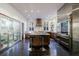 Gourmet kitchen with stainless steel appliances, subway tile backsplash, barstool seating at island, and dark hardwood floors at 388 Beverly Ne Rd, Atlanta, GA 30309