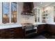 Kitchen featuring stainless steel oven, custom cabinets, marble countertops, and large windows with natural light at 388 Beverly Ne Rd, Atlanta, GA 30309