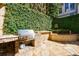 Outdoor stone kitchen featuring a gas grill and lush greenery backdrop at 388 Beverly Ne Rd, Atlanta, GA 30309