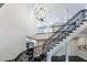 Grand staircase with wrought iron railing and decorative chandelier, offering an elegant architectural detail at 388 Beverly Ne Rd, Atlanta, GA 30309