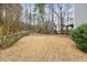 Large backyard featuring a mix of grass and natural growth, enclosed by a wooden fence for privacy at 69 New Brunswick Ct, Suwanee, GA 30024