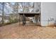 Backyard view of a deck with stairs, showing the landscape, and the building's foundation at 69 New Brunswick Ct, Suwanee, GA 30024