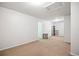 Expansive basement featuring neutral carpet, white walls, simple shelving, and offering space for customization at 69 New Brunswick Ct, Suwanee, GA 30024