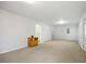 Finished basement features neutral-colored walls, carpet flooring, and a white access door at 69 New Brunswick Ct, Suwanee, GA 30024