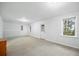 Finished basement space features carpeting, natural light, and a white door at 69 New Brunswick Ct, Suwanee, GA 30024