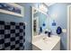 Bathroom with a white sink and vanity cabinet, framed mirror, and nautical themed decorations at 69 New Brunswick Ct, Suwanee, GA 30024