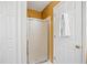 Bathroom with a shower/tub combo behind glass door and white towels at 69 New Brunswick Ct, Suwanee, GA 30024