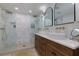 Luxurious bathroom with dual vanities, a frameless glass shower, and stylish fixtures, designed for relaxation at 8404 Majors Rd, Cumming, GA 30041