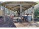 Close-up of the chicken coop with a metal roof, wire fencing and chickens in the enclosure at 8404 Majors Rd, Cumming, GA 30041