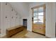 Cozy foyer featuring board and batten, hardwood floors, hall tree, and a wooden door at 8404 Majors Rd, Cumming, GA 30041