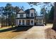 Beautiful two-story home with a covered porch and mature trees on a sunny day at 8404 Majors Rd, Cumming, GA 30041