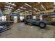 Spacious garage with high ceilings, ample storage, and a car under a gray cover at 8404 Majors Rd, Cumming, GA 30041