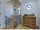 Bright hallway with wood floors, an elegant chandelier, modern railings, and a stylish, rustic wood chest at 8404 Majors Rd, Cumming, GA 30041