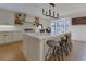 Kitchen featuring large island, stainless steel appliances, white cabinetry, and modern light fixture at 8404 Majors Rd, Cumming, GA 30041