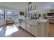 Bright kitchen featuring a large island, stainless steel appliances, and many windows providing natural light at 8404 Majors Rd, Cumming, GA 30041