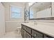 Well-lit bathroom featuring a modern vanity with a sleek countertop and decorative mirror at 1590 Greyson Rdg, Marietta, GA 30062