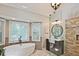 Bright bathroom featuring a soaking tub in front of a bay window and a glass shower with a tiled wall at 1590 Greyson Rdg, Marietta, GA 30062