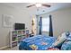 bedroom with blue bedding, a window with blue curtains, and a white storage cube unit with books at 1590 Greyson Rdg, Marietta, GA 30062