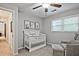 Bedroom featuring a white crib, gray chair, and footstool at 1590 Greyson Rdg, Marietta, GA 30062