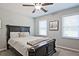 Bedroom with a dark wooden bed, white bedding, and two windows at 1590 Greyson Rdg, Marietta, GA 30062