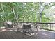 Outdoor deck with grill and dining set; overlooking wooded backyard at 1590 Greyson Rdg, Marietta, GA 30062