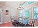 Bright dining room with a glass table, wrought iron chairs, and a modern chandelier at 1590 Greyson Rdg, Marietta, GA 30062