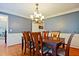 Traditional dining room featuring hardwood floors, wainscoting, and elegant chandelier at 1590 Greyson Rdg, Marietta, GA 30062