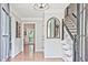 Bright foyer featuring hardwood floors, staircase, elegant lighting, and mirror accent at 1590 Greyson Rdg, Marietta, GA 30062