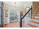 Bright foyer featuring hardwood floors, staircase, elegant lighting, and playroom access at 1590 Greyson Rdg, Marietta, GA 30062