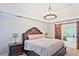 Primary bedroom features custom lighting and sliding barn door to en suite bathroom at 1590 Greyson Rdg, Marietta, GA 30062