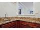 Attractive wet bar showcasing wood cabinets and a granite countertop at 1590 Greyson Rdg, Marietta, GA 30062