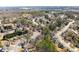 Sprawling aerial view of a mature neighborhood featuring winding streets and wooded lots at 3595 Ansley Park Dr, Suwanee, GA 30024