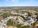 A wide aerial view showcases the expansive neighborhood and lush greenery surrounding the homes at 3595 Ansley Park Dr, Suwanee, GA 30024