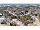 An aerial view shows a neighborhood with mature trees and well-maintained homes at 3595 Ansley Park Dr, Suwanee, GA 30024