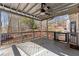 Relaxing covered back deck with ceiling fan and views of mature trees at 3595 Ansley Park Dr, Suwanee, GA 30024