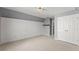 Spacious carpeted bedroom with white shiplap accent wall, closet and gray walls at 3595 Ansley Park Dr, Suwanee, GA 30024