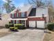 Brick house with well-kept lawn, two-car garage, basketball hoop, and trimmed hedges at 3595 Ansley Park Dr, Suwanee, GA 30024