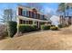 Inviting two-story brick home with a well-maintained lawn and lush landscaping at 3595 Ansley Park Dr, Suwanee, GA 30024