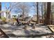 Backyard firepit surrounded by gravel and mature trees at 3595 Ansley Park Dr, Suwanee, GA 30024