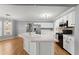 Bright kitchen with white cabinets, a large island, and stainless steel appliances at 3595 Ansley Park Dr, Suwanee, GA 30024