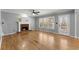 Bright living room features a fireplace, hardwood floors, and multiple windows at 3595 Ansley Park Dr, Suwanee, GA 30024