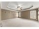 This is the spacious main bedroom, featuring a tray ceiling and lots of natural light at 3595 Ansley Park Dr, Suwanee, GA 30024