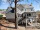 Home's rear exterior features wood deck, staircase, and backyard access at 3595 Ansley Park Dr, Suwanee, GA 30024