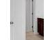 Doorway view into a bathroom with a tile floor and dark cabinets at 4201 Brindle Pl, Loganville, GA 30052