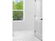 View into a bathroom with white tiling and a door at 4201 Brindle Pl, Loganville, GA 30052